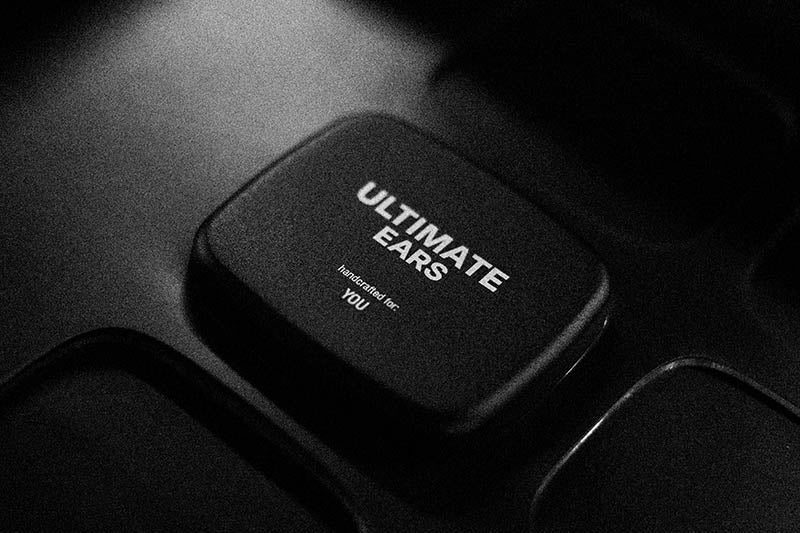 Black IEM case with 'Ultimate Ears' branding on a dark background